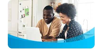 Couple in kitchen with laptop